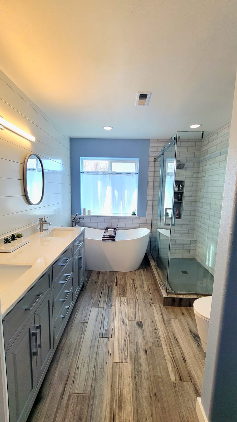 Bathroom remodel with new glass shower and vinyl floor